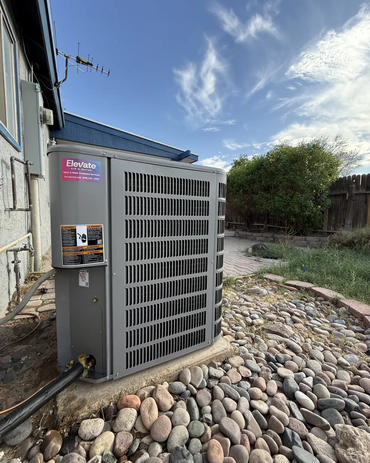 New outdoor AC unit with an Elevate sticker, installed by the Elevate team