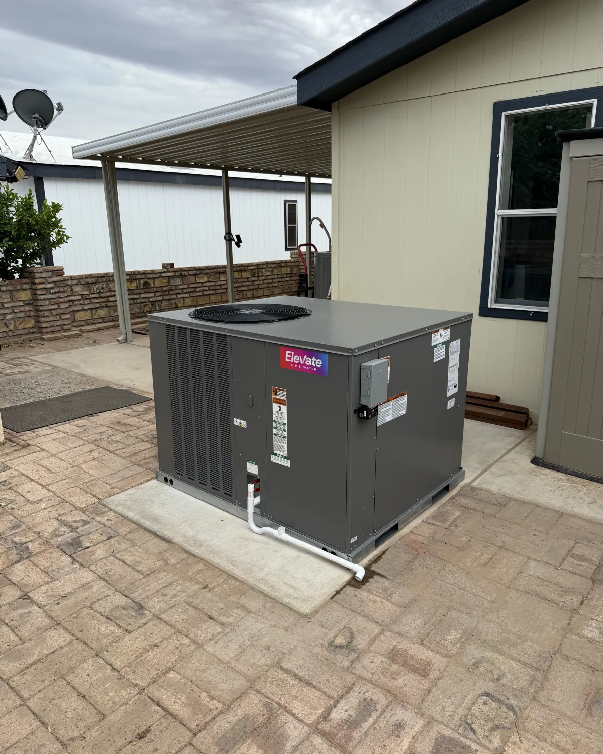 Packaged HVAC unit installed on pavers by the Elevate team