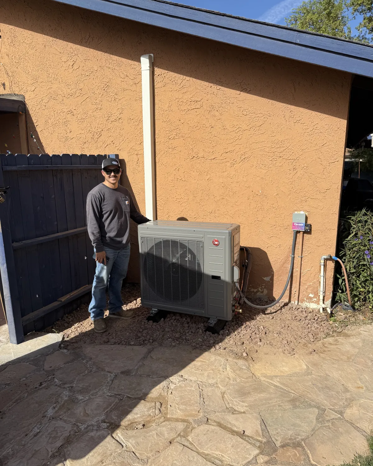 Elevate technician next to a newly installed mini-split