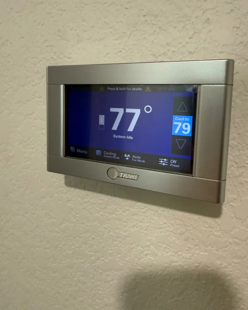 Trane touchscreen thermostat on a wall, installed by Elevate